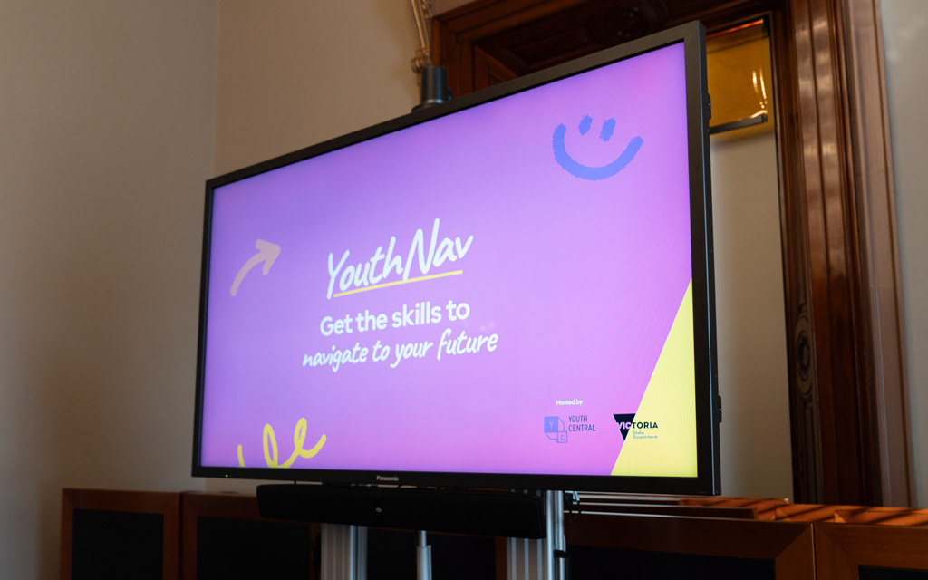 A large screen displaying a slide that says YouthNav.