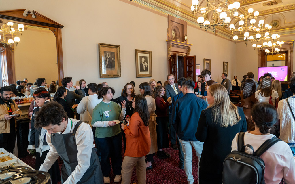 A large crowd gathering in a room at Parliament House.