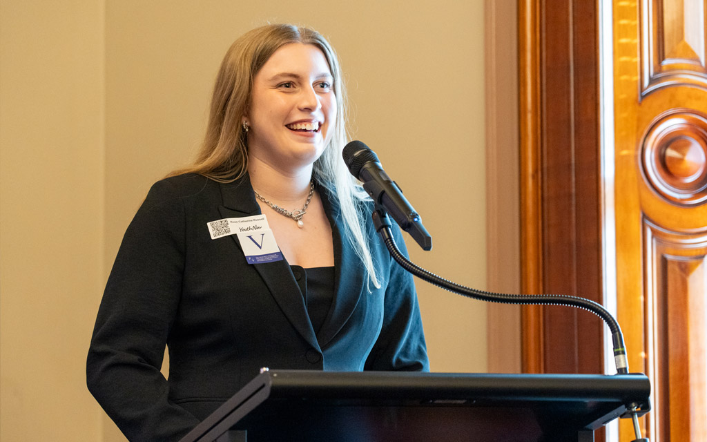 A woman speaking into a microphone.